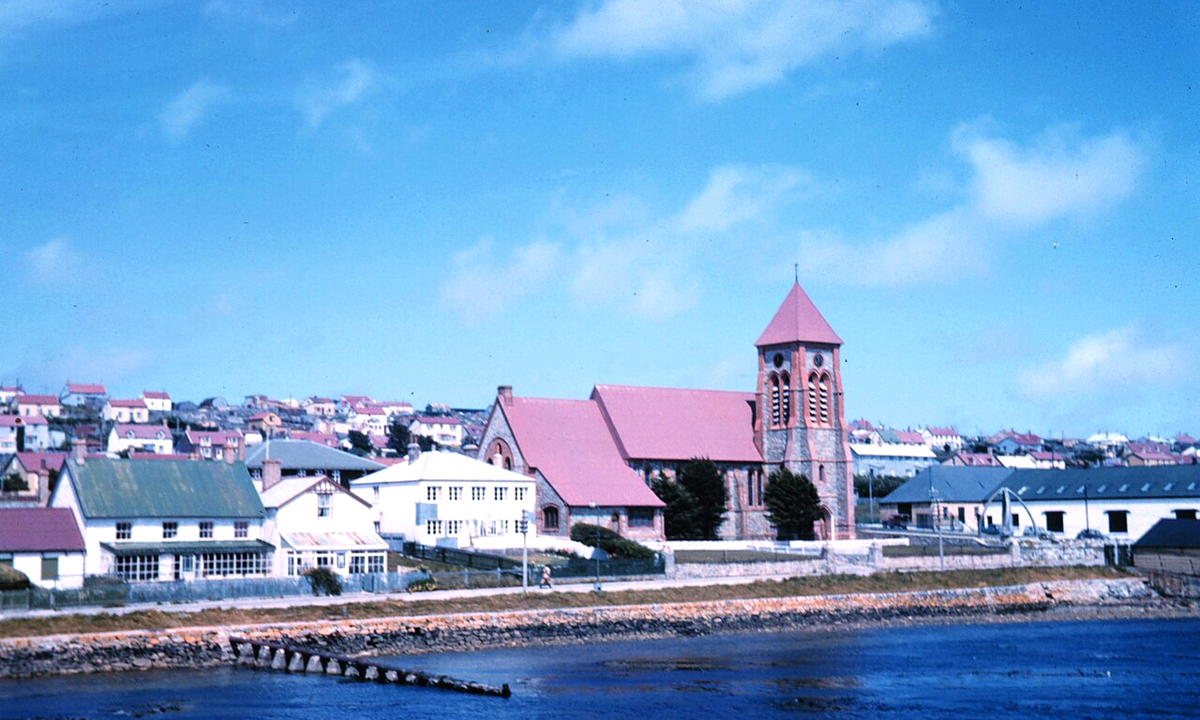 Port Stanley, Falkland Islands, viewed from the sea in December 1961. Photograph by Harley D. Nygren, NOAA At The Ends of the Earth Collection (corp1373). Public domain.