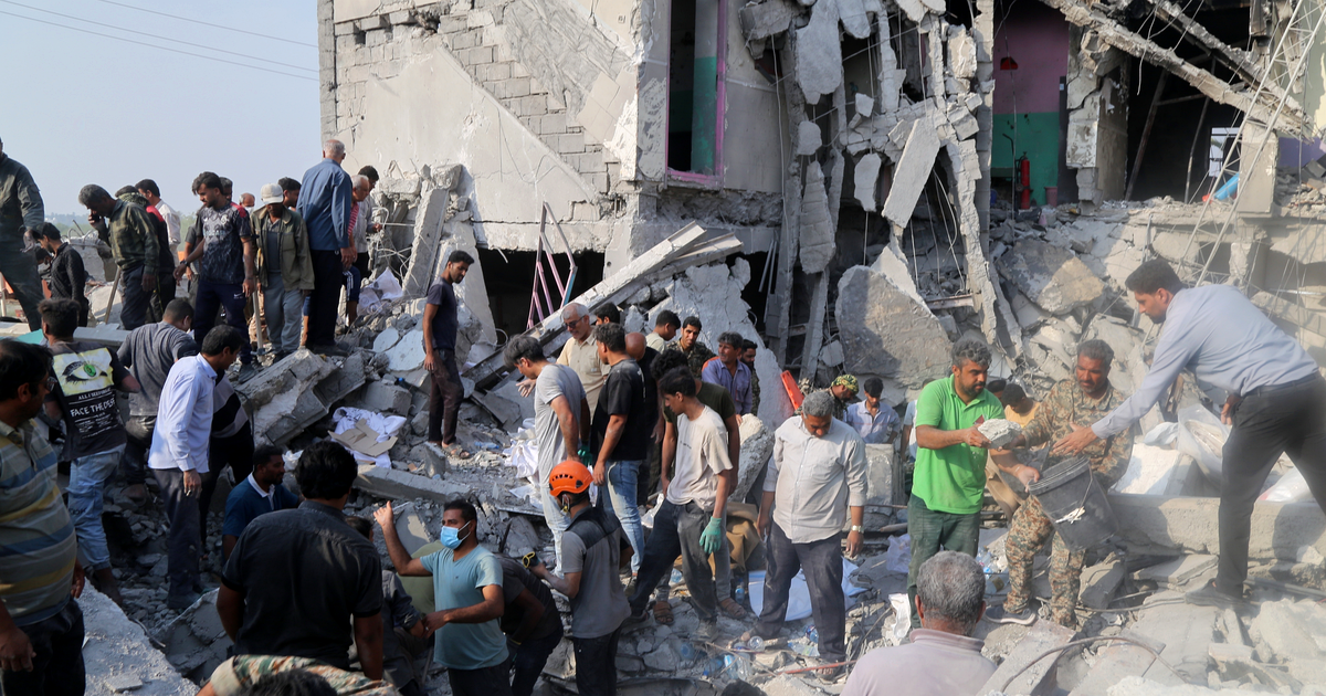 Archival photograph, 28 February 2026: rescuers search the rubble of the Shajareh Tayyebeh Primary School in Minab, Hormozgan province, Iran. Photograph: Abbas Zakeri / Mehr News Agency via Wikimedia Commons, CC BY 4.0, cropped.