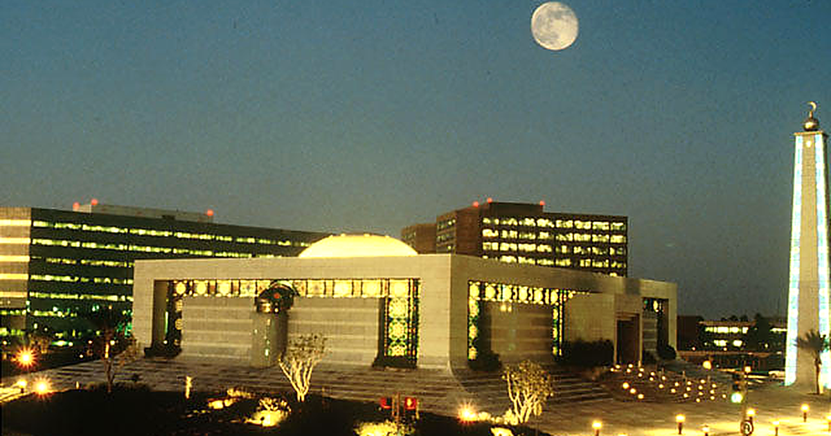 Saudi Aramco headquarters core area in Dhahran, archival photograph of administration towers behind a mosque (2005).