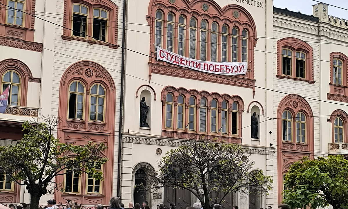 A "Studenti pobeđuju!" ("Students Win!") banner on the University of Belgrade rectorate building during a rally for the student-backed election list, Belgrade, 14 September 2026. Photograph: Novosloven via Wikimedia Commons, CC0.