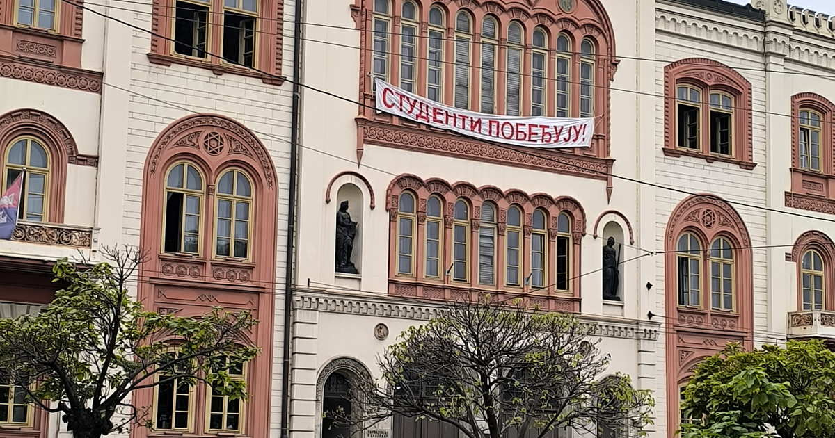 A "Studenti pobeđuju!" ("Students Win!") banner on the University of Belgrade rectorate building during a rally for the student-backed election list, Belgrade, 14 September 2026. Photograph: Novosloven via Wikimedia Commons, CC0.