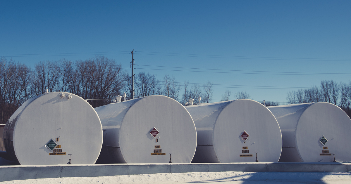 Four white fuel storage tanks on snow under a blue sky in Faribault, Minnesota, with diamond signs reading #2 clear diesel and #2 dyed diesel. Photograph: Tony Webster / Wikimedia Commons, CC BY 2.0.