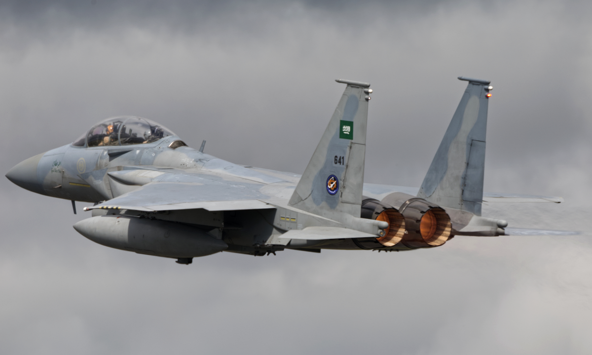 A Royal Saudi Air Force F-15SA Eagle fighter jet in flight against a grey sky, July 2024. Photograph: Ronnie Macdonald / Wikimedia Commons, CC BY 2.0.